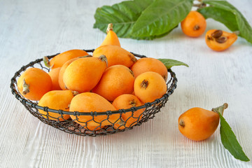 Loquat Medlar fruit with leaves in metal basket