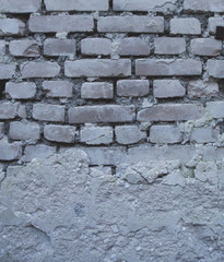 Old brick wall of an abandoned house background texture