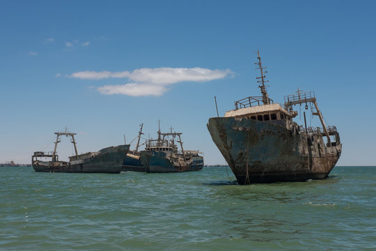 Ship graveyard with several abandoned shipwrecks (rusty fishing trawlers) near Nouadhibou, Mauritania