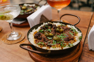 Detail of a pan with rice and beans decorated with chopped chilies