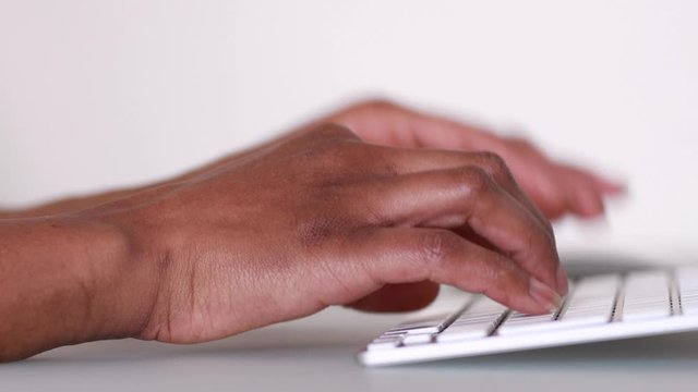 African American person typing on a laptop keyboard- Black people 