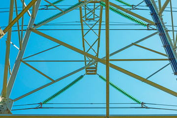 The esthetic side of the construction of a transmission tower in a blue sky in sunlight in spring