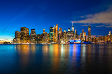 Plakat Famous Skyline of downtown New York, Brooklyn Bridge and Manhattan at night , New York City USA .
