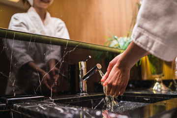 Young woman standing in the spa bathroom.