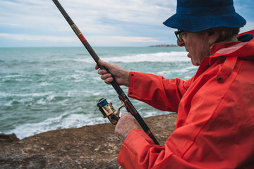 Senior man fishing in the sea.