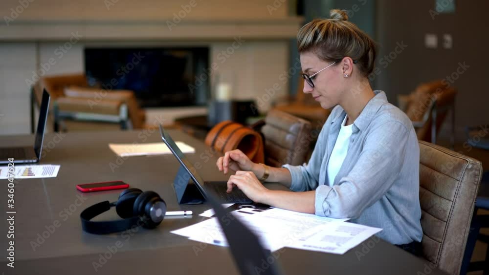 Poster time lapse effect of young woman in casual wear using cellphone device for calling while working wit