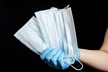 Face masks, disposable medical sanitary surgical masks in hand