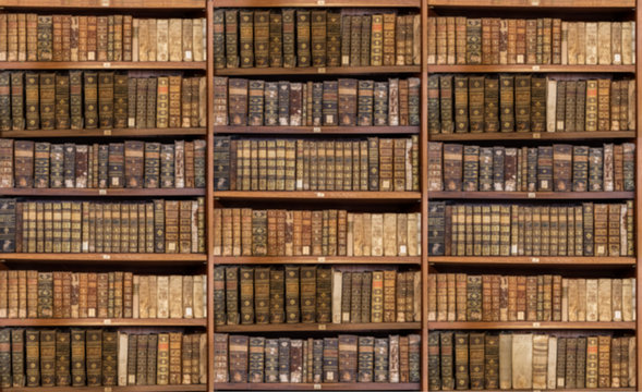 Defocused and blurred image of old antique library books on shelves for use in video conferencing background