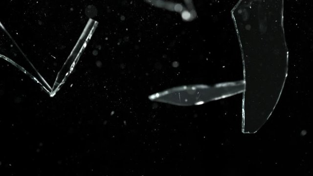 Super Slow Motion Shot of Falling Shards at 1000 fps Isolated on Black Background.