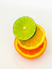 lime lemon and orange sliced and stacked on white