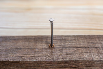 iron nail on a wooden table, Using hammer and nail on wood  background.