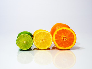 sliced limes lemons and oranges on white background