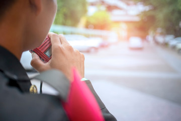 Security guard uses radio communication for facilitate traffic. Traffic Officers use walkie talkie...