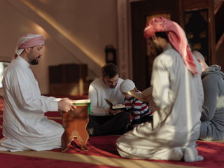 muslim people in mosque reading quran together