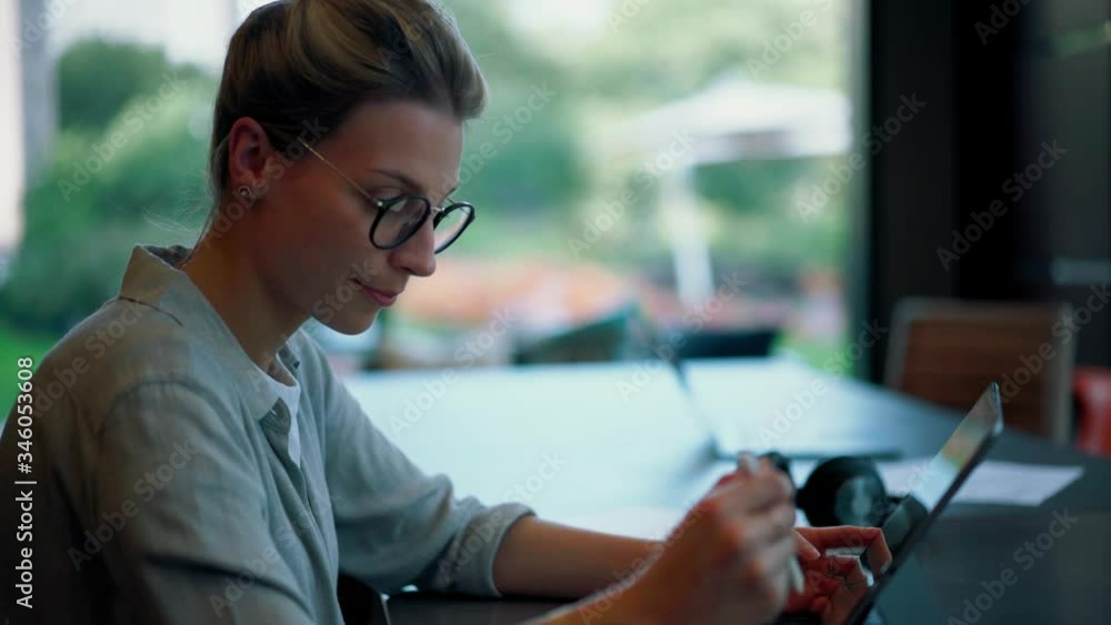Poster talented female graphic designer working remotely in modern workspace using electronic pen for drawi