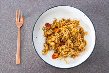 plant-based food, vegan ginger noodles with pickeld capsicum and roasted cashew