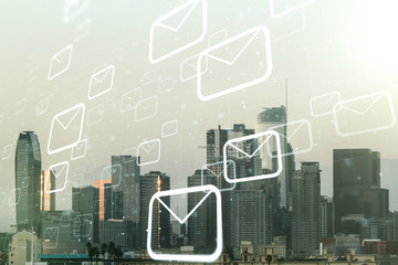 Abstract virtual postal envelopes sketch on Los Angeles office buildings background, e-mail and marketing concept. Double exposure