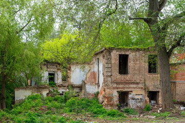 Old dilapidated red brick house without windows and roof