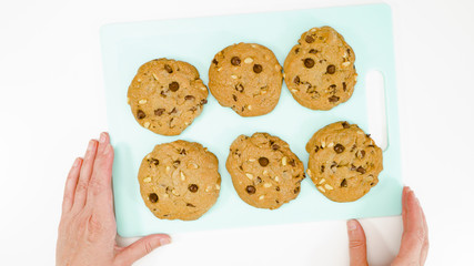 Chocolate Chip Cookies with pine nuts close up on a serving board. Homemade old-fashioned Chocolate Chip Cookies. American cuisine, dessert