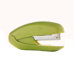 Green stapler isolated on white background