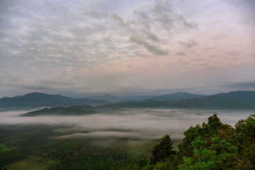 Fototapeta premium Scenery of mountains under mist in the morning in Thailand.