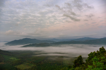 Scenery of mountains under mist in the morning in Thailand.