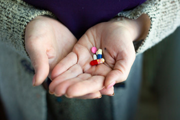 Drugs in old woman's hands. Close up photo. Lifestyle photo.