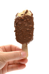 hand holding a chocolate and coffee flavor popsicle with a bite on white background with clipping path