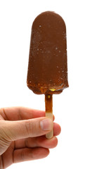 hand holding a fresh chocolate flavor popsicle on white with clipping path