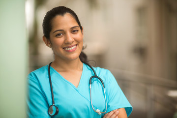 Happy Hispanic medial provider at work stock photo.