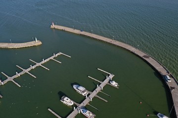Small sea lagoon port and two lighthouses on pier, aerial view