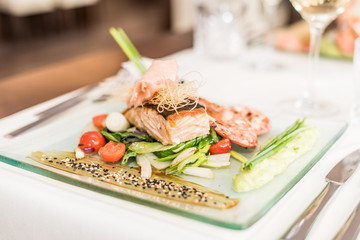 Asian dish with shrimp, salmon and sauce