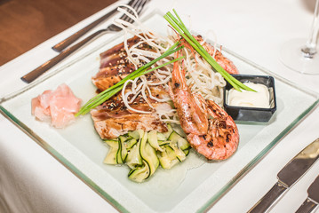 Asian dish with shrimp, salmon and sauce