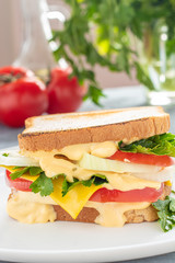 sandwich with cheese sauce, lettuce, tomato slice