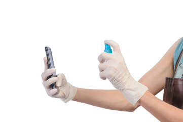 Fototapeta premium Protection Coronavirus and Bacteria through touch concept. Close up hands of asian woman in Rubber gloves cleaning mobile phone by sanitizer gel. for protect and clean from virus on white background.