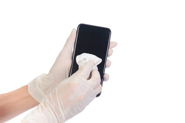 Health care and protection Bacteria through touch concept. Close up women's hands wear rubber gloves, using alcohol spray to wipe clean a mobile phone to prevent viruses or germs on isolate of white.