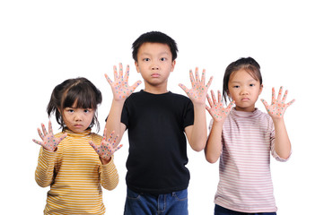Children health care for germs and touch concepts. Three little Asian boy and girls shocking by bacteria on hands. 3 Kids doing gestures and expressing very shocked and raise hands to hold near face.