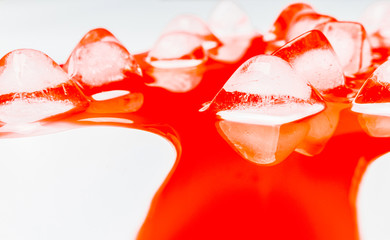 Ice cube in red blood on white background,abstract wallpaper