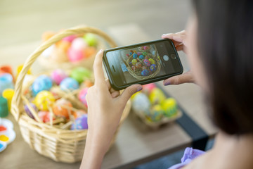 Asian young pretty woman enjoy taking a photo to the colorful fantasy Easter egg 