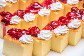 Patterns of strawberry cheesecake with cream on white background dish. Many pieces of strawberry cheesecake. Dessert cake buffet.