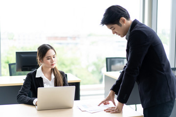 Asian businesspeople talk and discuss together in their office about business plan. Modern businesspeople working together in the modern working space. Good team work and good colleagues concept.