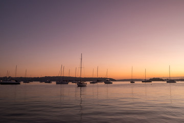 serene scene with yachts on the water at dawn
