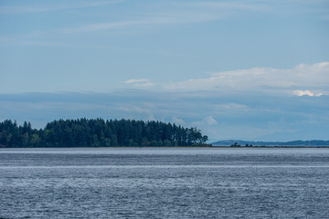 Obraz na płótnie Canvas Haro strait view from Vancouver island with cloudy sky British Columbia Canada.