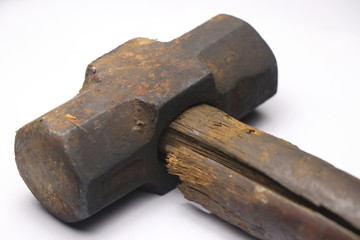 Old and rusty hammer with cracked wooden handle