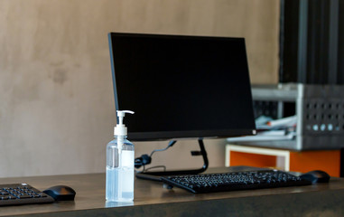 Fototapeta premium Hand sanitizer alcohol gel pump bottle on the table in office, Health care and COVID-19 Coronavirus concept