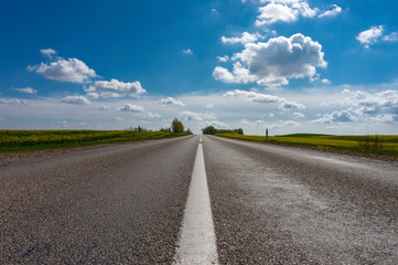 Low angle view of a tarred road receding