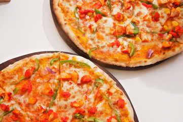 A chicken pizza served on a table ready to eat