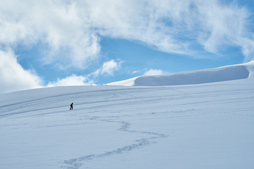 Image of a snow covered mountain plateau. Tourists walk and take pictures on a mountain plateau.