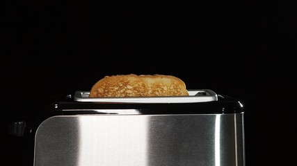 Video of a steel toaster making hot toast for breakfast.