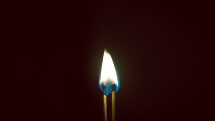 Couple of matches burning together with heat flame isolated on a black background